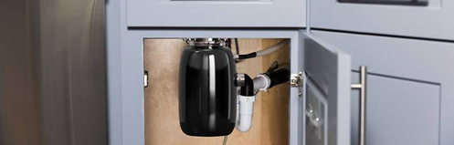 Garbage disposal tank under a sink