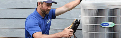 Stan's employee performing maintenance on an AC unit