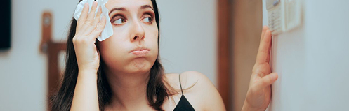 Woman sweating with a washcloth on her head
