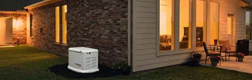 Evening lit home with a generator sitting outside as the main focus