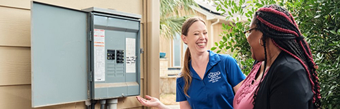 Stan's employee showing a woman tips on her breaker panel