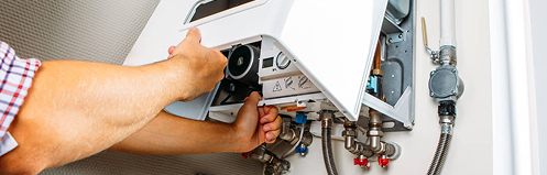 Man inspecting tankless water heater