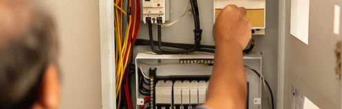 Person fixing an electrical panel